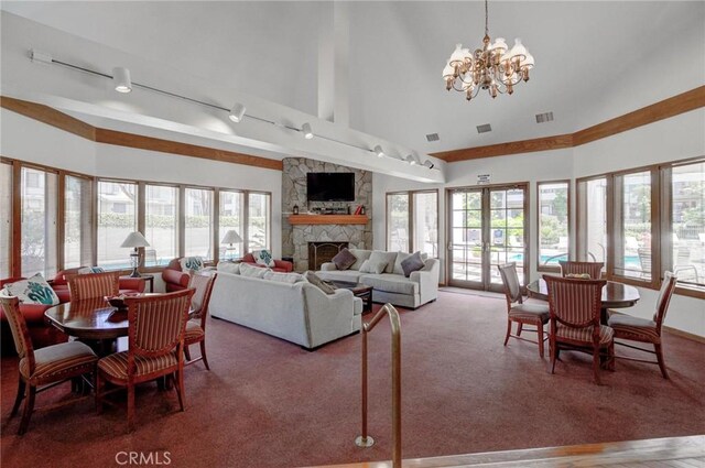 2563 Plaza Del Amo Unit 312, Torrance, CA 90503 - carpeted dining space with a fireplace, a chandelier, rail lighting, and high vaulted ceiling