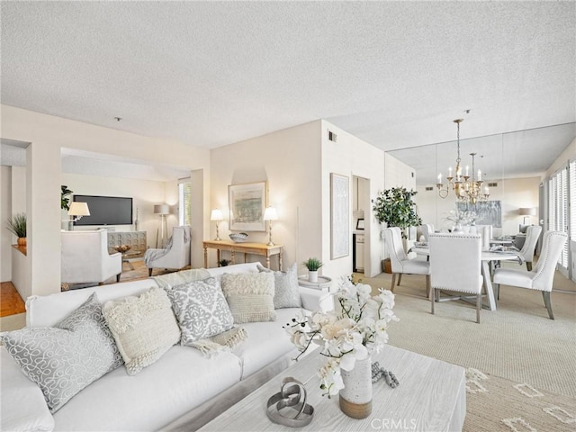 2563 Plaza Del Amo Unit 312, Torrance, CA 90503 - carpeted living area featuring a textured ceiling and a chandelier