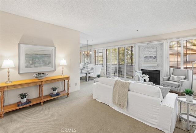 2563 Plaza Del Amo Unit 312, Torrance, CA 90503 - living room with carpet flooring, a textured ceiling, a chandelier, and a fireplace