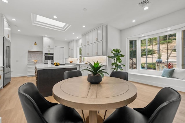18150 Via Ascenso, Rancho Santa Fe, CA 92067 - dining room with light wood-type flooring, a skylight, recessed lighting, and baseboards