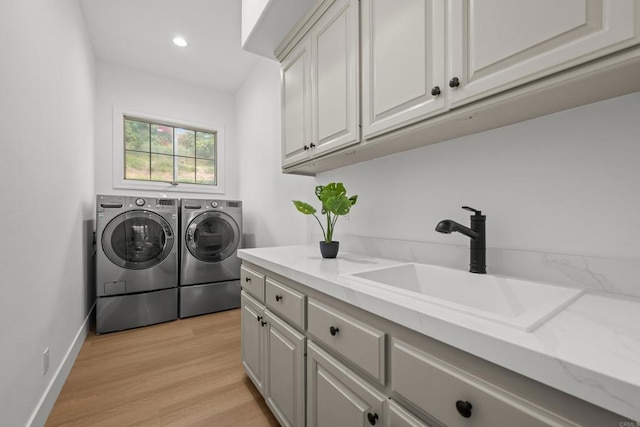 18150 Via Ascenso, Rancho Santa Fe, CA 92067 - laundry area with washer and dryer, cabinet space, light wood finished floors, recessed lighting, and baseboards