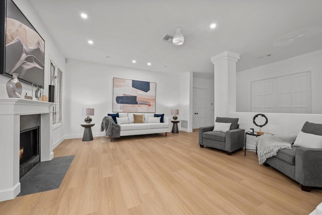 18150 Via Ascenso, Rancho Santa Fe, CA 92067 - living room featuring ornate columns, light wood finished floors, a fireplace with flush hearth, recessed lighting, and baseboards