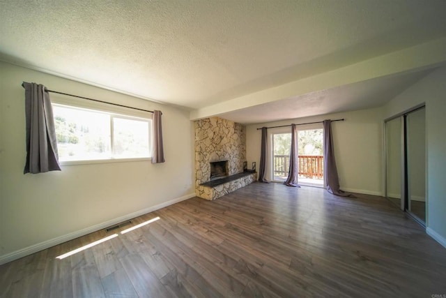 8637 Ponderosa Ln, Pine Valley, CA 91962 - unfurnished living room with a textured ceiling, baseboards, wood finished floors, and a fireplace