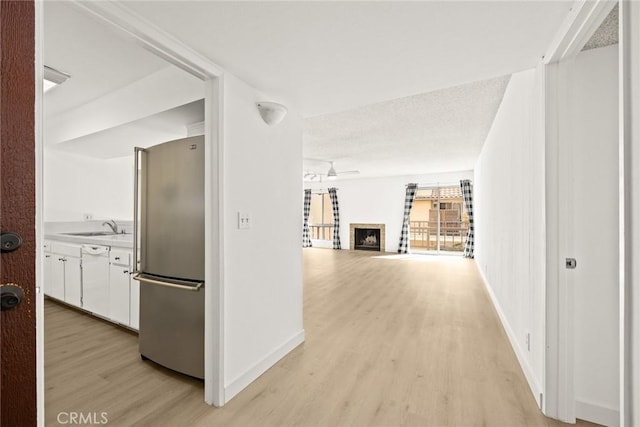 1127 E Del Mar Blvd Unit 235, Pasadena, CA 91106 - hall with light wood-style flooring, a sink, and baseboards