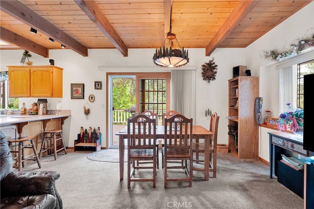 908 Knickerbocker Rd, Big Bear Lake, CA 92315 - dining area with light carpet, wood ceiling with exposed beams, and plenty of natural light