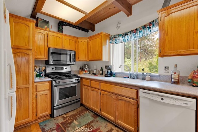 908 Knickerbocker Rd, Big Bear Lake, CA 92315 - kitchen featuring stainless steel appliances, a sink, beamed ceiling, wood finished floors, and light countertops