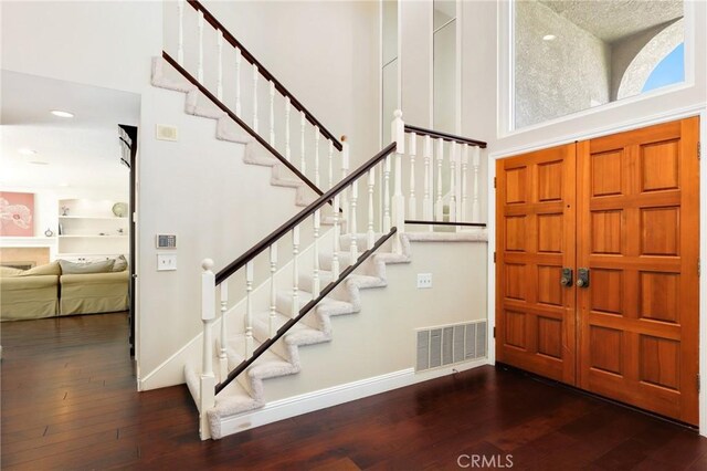 24092 Lapwing Ln, Laguna Niguel, CA 92677 - foyer with a high ceiling, wood-type flooring, stairway, and baseboards