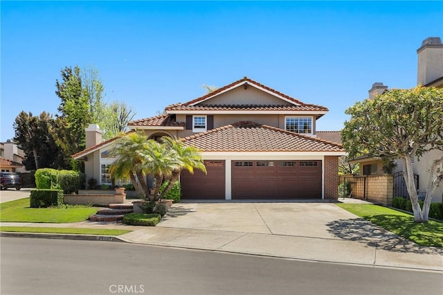 24092 Lapwing Ln, Laguna Niguel, CA 92677 - mediterranean / spanish-style home featuring an attached garage, a tiled roof, concrete driveway, and stucco siding