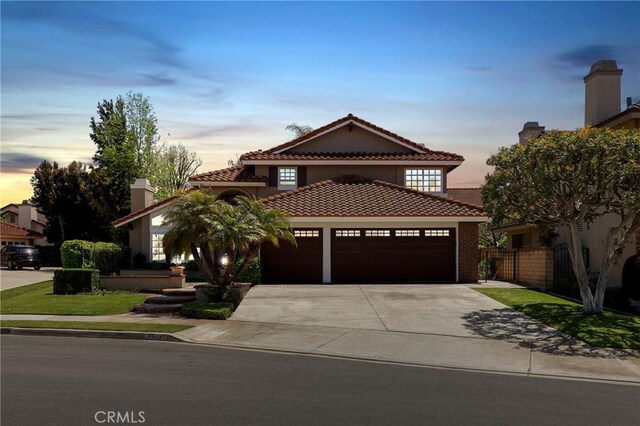 24092 Lapwing Ln, Laguna Niguel, CA 92677 - mediterranean / spanish-style home featuring an attached garage, a tile roof, concrete driveway, and stucco siding