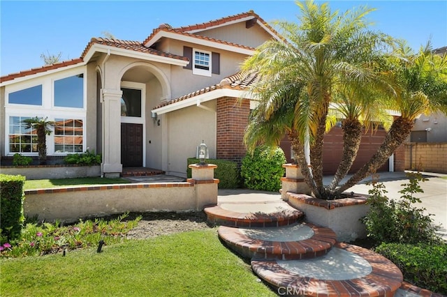 24092 Lapwing Ln, Laguna Niguel, CA 92677 - mediterranean / spanish home with driveway, a tile roof, stucco siding, and an attached garage