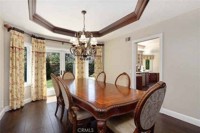 24092 Lapwing Ln, Laguna Niguel, CA 92677 - dining space with a chandelier, a raised ceiling, baseboards, crown molding, and dark wood finished floors