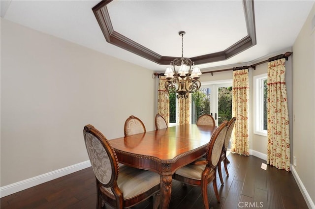 24092 Lapwing Ln, Laguna Niguel, CA 92677 - dining space with a chandelier, ornamental molding, baseboards, a tray ceiling, and dark wood finished floors