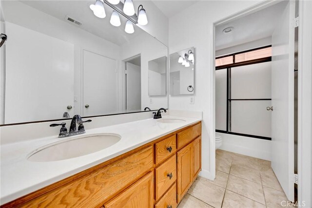 867 Winding Brook Ln, Walnut, CA 91789 - bathroom with toilet, double vanity, enclosed tub / shower combo, and tile patterned flooring