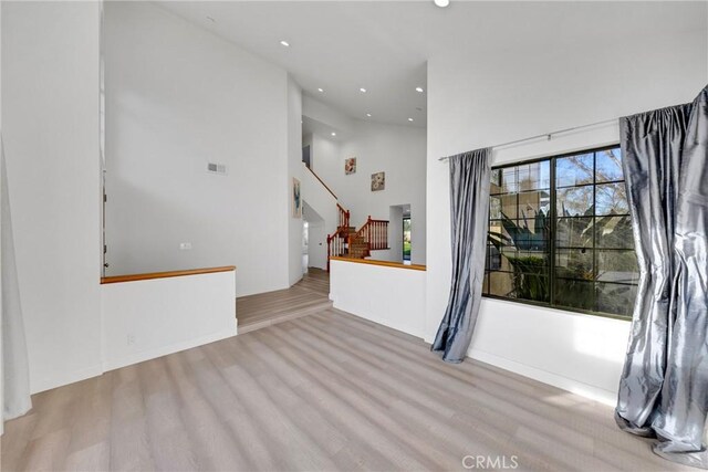 867 Winding Brook Ln, Walnut, CA 91789 - spare room with recessed lighting, wood finished floors, stairs, and high vaulted ceiling