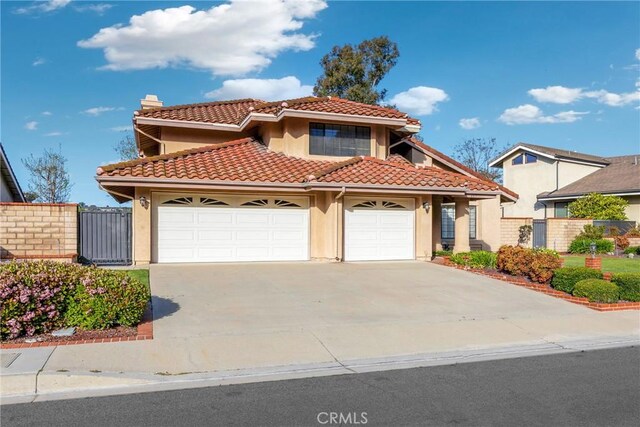 867 Winding Brook Ln, Walnut, CA 91789 - mediterranean / spanish-style home featuring stucco siding, a tile roof, a garage, concrete driveway, and a chimney