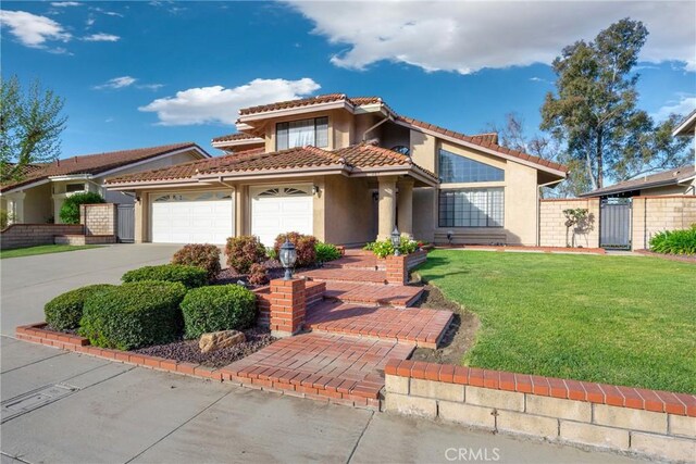 867 Winding Brook Ln, Walnut, CA 91789 - mediterranean / spanish-style home with stucco siding, driveway, an attached garage, a gate, and a tiled roof