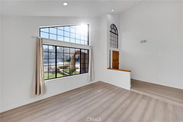 867 Winding Brook Ln, Walnut, CA 91789 - unfurnished living room with wood finished floors, healthy amount of natural light, a towering ceiling, and recessed lighting