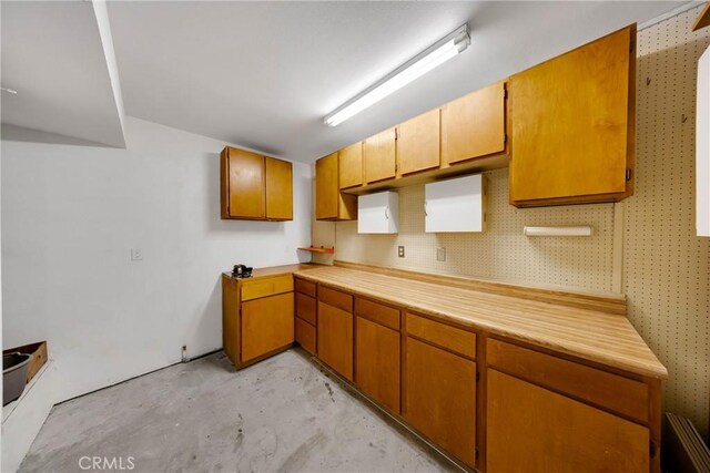 867 Winding Brook Ln, Walnut, CA 91789 - kitchen featuring unfinished concrete flooring, light countertops, and brown cabinets