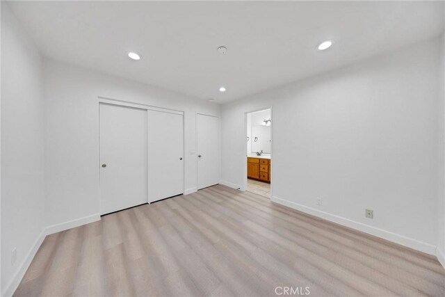 867 Winding Brook Ln, Walnut, CA 91789 - unfurnished bedroom with baseboards, recessed lighting, light wood-style flooring, multiple closets, and connected bathroom