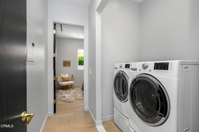 5622 Natick Ave, Sherman Oaks, CA 91411 - washroom with separate washer and dryer, light wood-style flooring, and baseboards