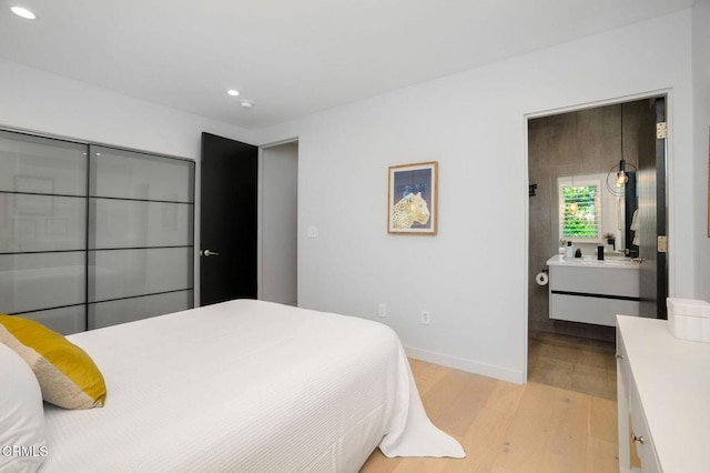 5622 Natick Ave, Sherman Oaks, CA 91411 - bedroom featuring light wood-style flooring, recessed lighting, baseboards, and a sink