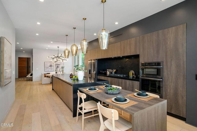 5622 Natick Ave, Sherman Oaks, CA 91411 - kitchen featuring modern cabinets, multiple ovens, a large island, recessed lighting, and light wood-style floors