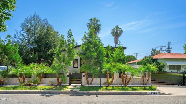 5622 Natick Ave, Sherman Oaks, CA 91411 - view of property hidden behind natural elements with a fenced front yard and a gate