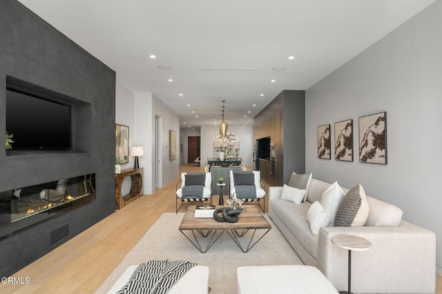 5622 Natick Ave, Sherman Oaks, CA 91411 - living room featuring light wood finished floors, recessed lighting, a chandelier, and a large fireplace