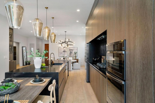 5622 Natick Ave, Sherman Oaks, CA 91411 - kitchen with modern cabinets, a sink, double oven, light wood-style floors, and recessed lighting