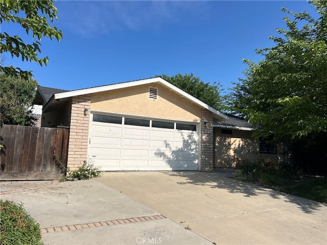 1748 Wade Dr, Paso Robles, CA 93446 - view of front facade featuring brick siding, stucco siding, driveway, and a garage