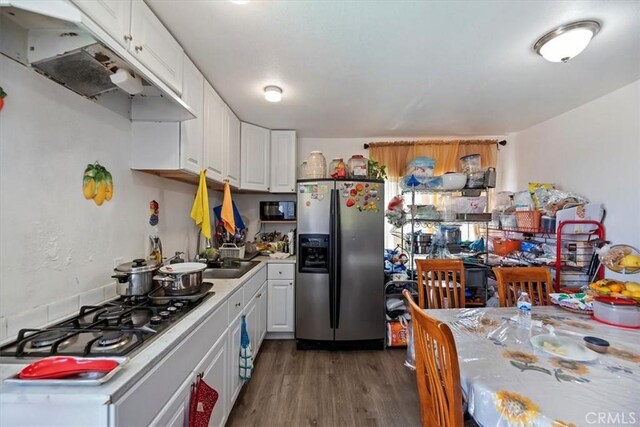 1218 S Sultana Ave Unit A, Ontario, CA 91761 - kitchen with stainless steel appliances, under cabinet range hood, light countertops, white cabinets, and wood finished floors