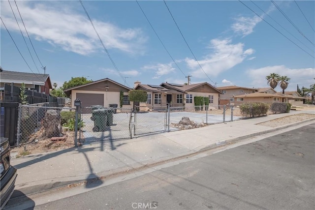 17196 Barbee St, Fontana, CA 92336 - view of front of property with a fenced front yard, a garage, solar panels, a gate, and a residential view