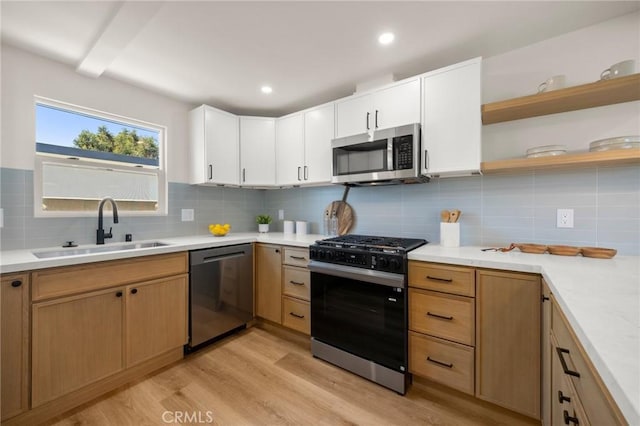3629 W 144th St, Hawthorne, CA 90250 - kitchen featuring stainless steel microwave, dishwashing machine, gas range, a sink, and light wood finished floors