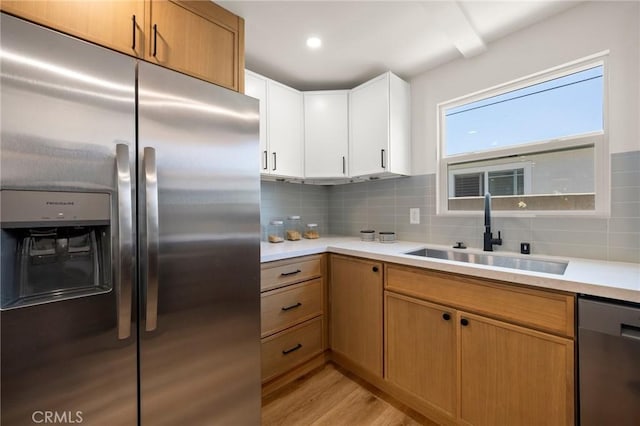 3629 W 144th St, Hawthorne, CA 90250 - kitchen featuring appliances with stainless steel finishes, a sink, light countertops, and decorative backsplash
