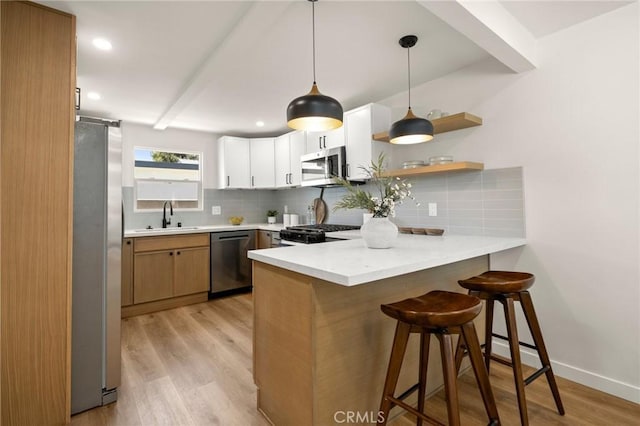 3629 W 144th St, Hawthorne, CA 90250 - kitchen featuring appliances with stainless steel finishes, a peninsula, a sink, backsplash, and recessed lighting