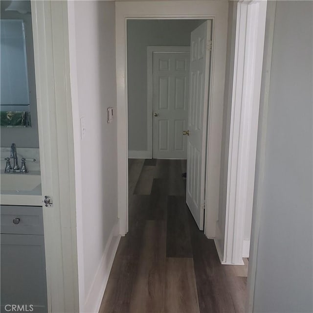 5846 Madden Ave, Los Angeles, CA 90043 - hall featuring a sink, dark wood-style flooring, and baseboards