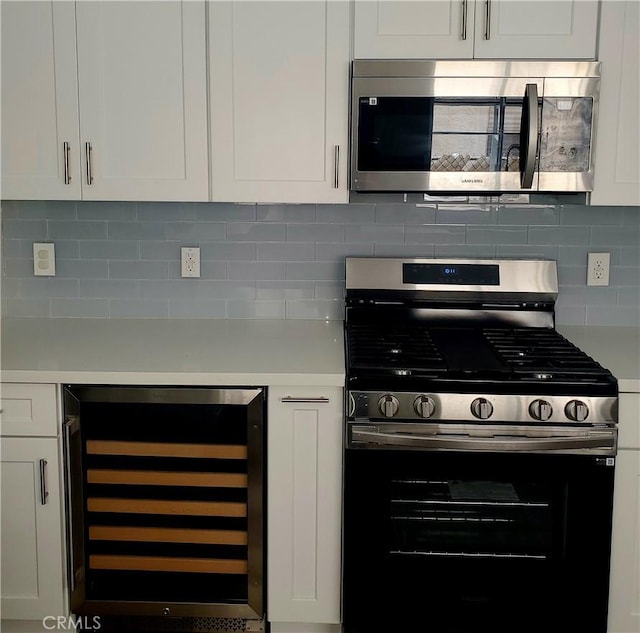 5846 Madden Ave, Los Angeles, CA 90043 - kitchen featuring stainless steel appliances, beverage cooler, light countertops, and white cabinets