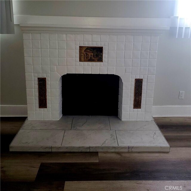 5846 Madden Ave, Los Angeles, CA 90043 - detailed view of a fireplace, wood finished floors, and baseboards