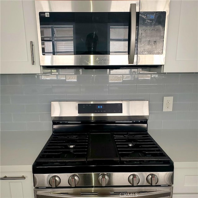 5846 Madden Ave, Los Angeles, CA 90043 - kitchen view of appliances with stainless steel finishes, white cabinetry, and backsplash