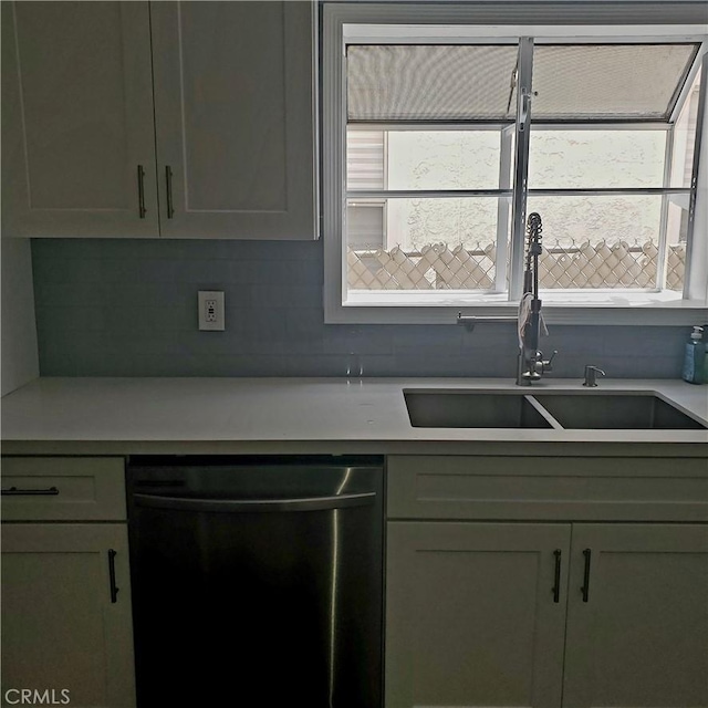5846 Madden Ave, Los Angeles, CA 90043 - kitchen with stainless steel dishwasher, a sink, light countertops, and backsplash