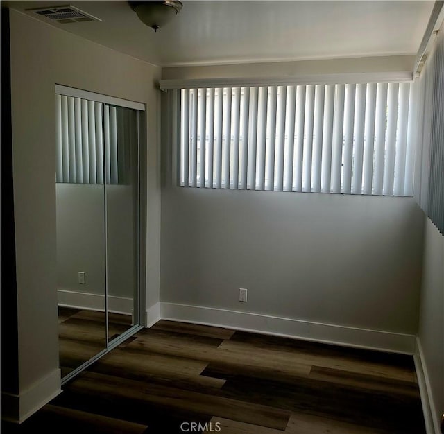 5846 Madden Ave, Los Angeles, CA 90043 - unfurnished bedroom featuring dark wood-type flooring, baseboards, and a closet