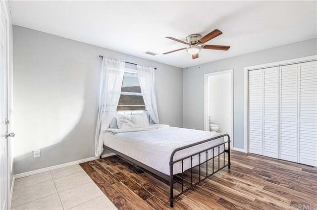 6683 Sherman Hoyt Ave Unit 29, Palms, CA 92277 - bedroom with baseboards, a closet, wood finished floors, and a ceiling fan