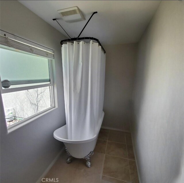 6683 Sherman Hoyt Ave Unit 29, Palms, CA 92277 - full bath featuring a freestanding tub, baseboards, tile patterned floors, and a shower with shower curtain