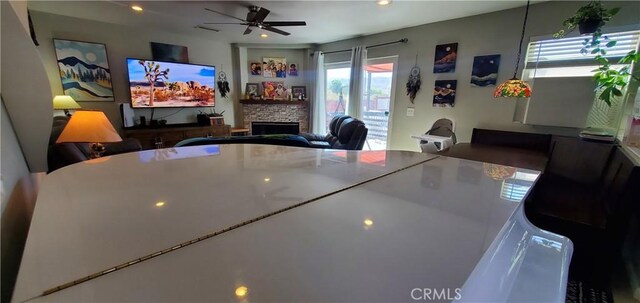 6683 Sherman Hoyt Ave Unit 29, Palms, CA 92277 - dining space with a stone fireplace, ceiling fan, and recessed lighting
