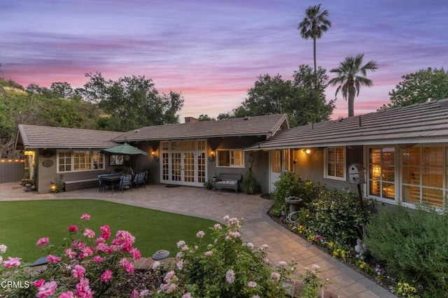 2210 Brambling Ln, Pasadena, CA 91107 - back of property featuring a patio area, french doors, a lawn, stucco siding, and a chimney