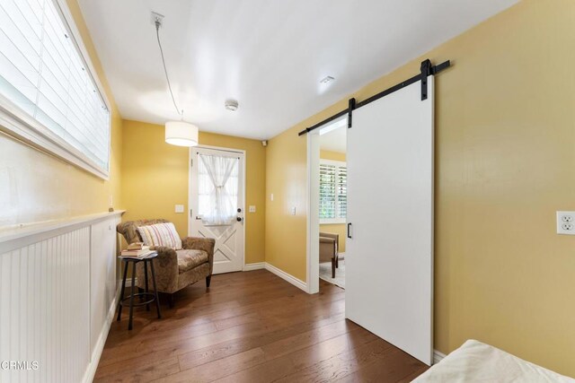 2210 Brambling Ln, Pasadena, CA 91107 - sitting room with a barn door and hardwood / wood-style flooring