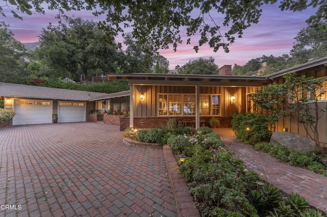 2210 Brambling Ln, Pasadena, CA 91107 - single story home with board and batten siding, a chimney, a garage, driveway, and brick siding