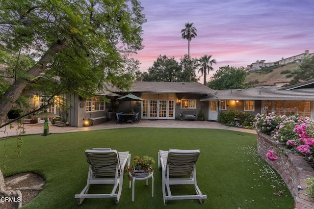 2210 Brambling Ln, Pasadena, CA 91107 - back of house at dusk featuring a patio area, french doors, and a lawn