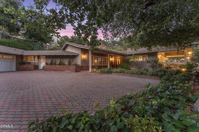 2210 Brambling Ln, Pasadena, CA 91107 - view of front facade featuring board and batten siding, an attached garage, and driveway