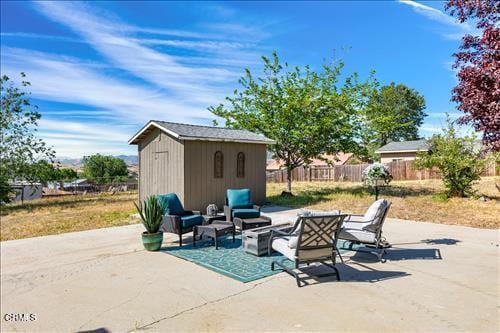 22150 Buena Vista St, Tehachapi, CA 93561 - view of patio / terrace with an outbuilding and an outdoor living space with a fire pit